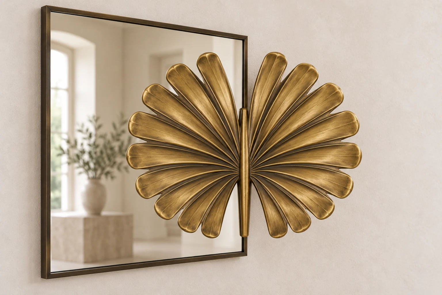 Fan Palm Echo sculptural mirror in warm brass tone, wide rectangular frame