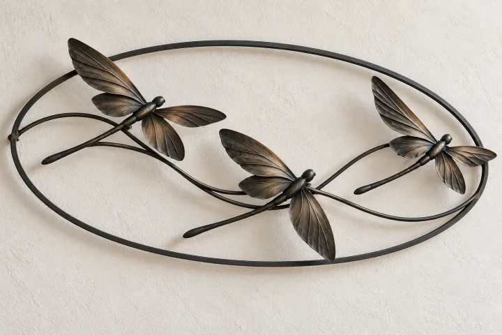 Dragonfly Crosswind open-frame wall art in dark iron tone, wide oval frame