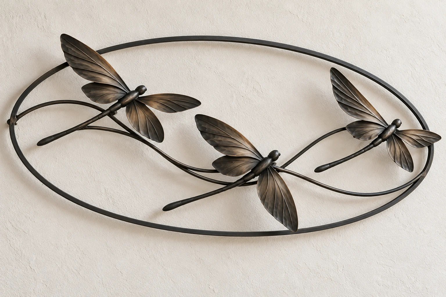 Dragonfly Crosswind open-frame wall art in dark iron tone, wide oval frame