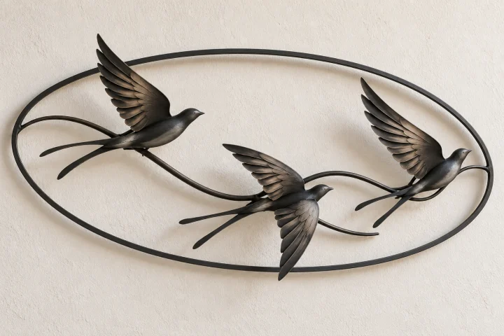 Swallow Current open-frame wall art in dark iron tone, horizontal oval frame