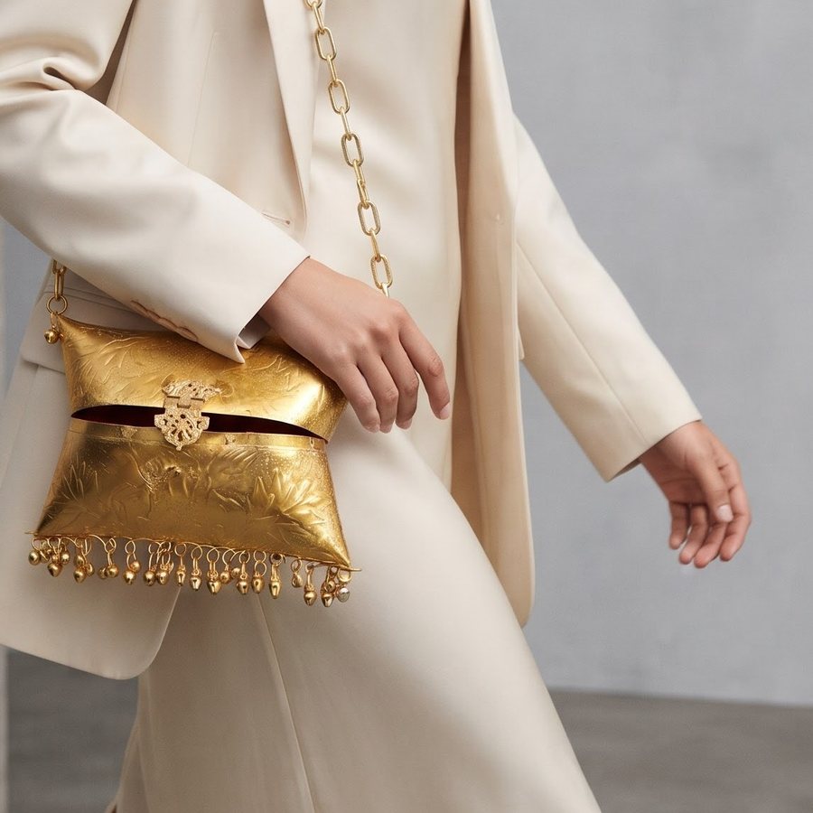 The Temple Bell Handbag — Hand-worked metal · polished gold-tone · red lining
