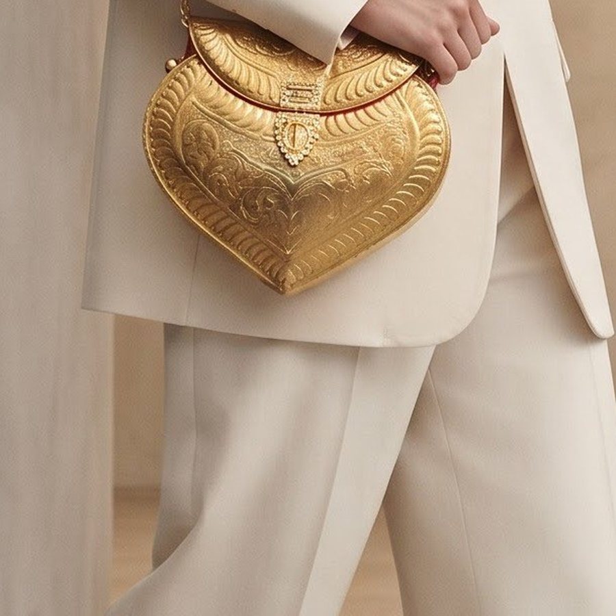 The Locket Handbag — Hand-worked metal · polished gold-tone · red lining