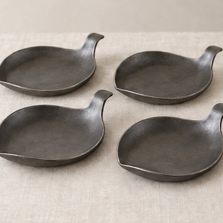 Turned-Edge Leaf Coaster Set — Iron with small felt underside contact pads · protected dark charcoal or satin black · concept render