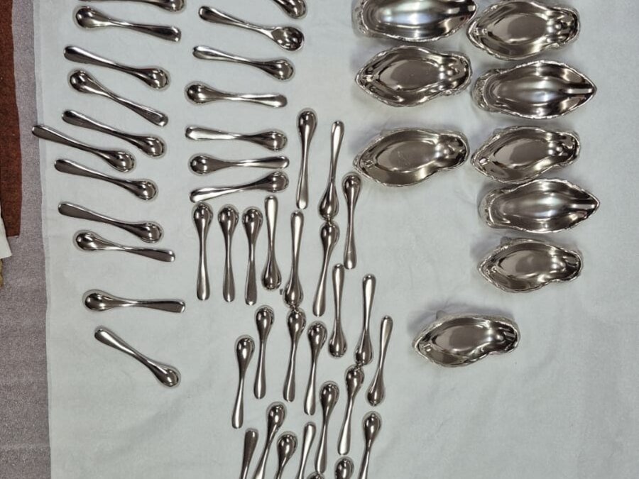 Silver-plated spoons and oyster serving dishes, hand-finished at scale